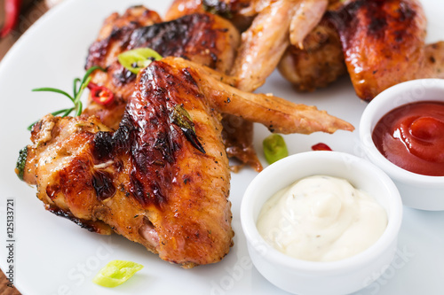 Baked chicken wings in the Asian style on plate.