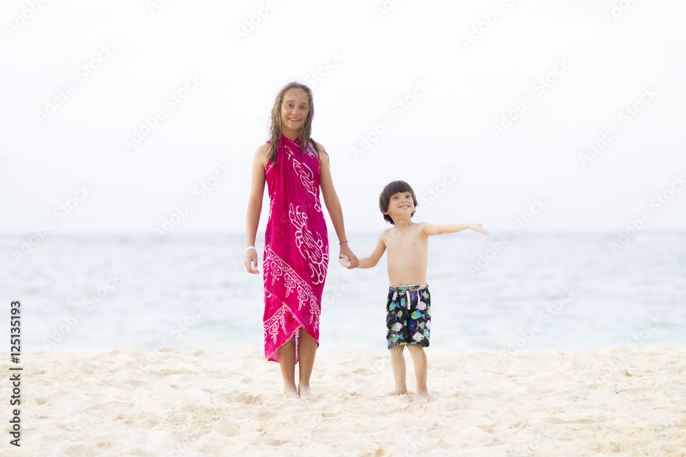Happy Girl and Boy Playing at the beach Happy Girl and Boy Playing at the beach