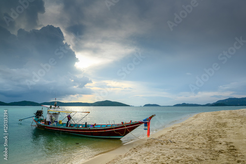 Fishing boat on sea side during about raining.