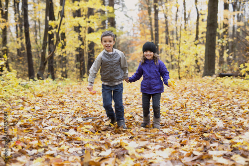 Happy children playing in beautiful autumn park