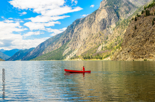 Majestic mountain lake in Canada. Seton Lake in British Columbia, Canada. Red canoe. © karamysh