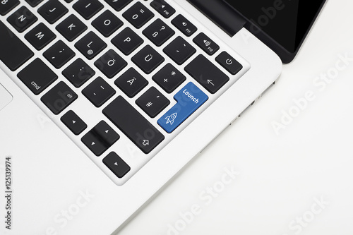 Laptop's keyboard with blue Launch key and copyspace