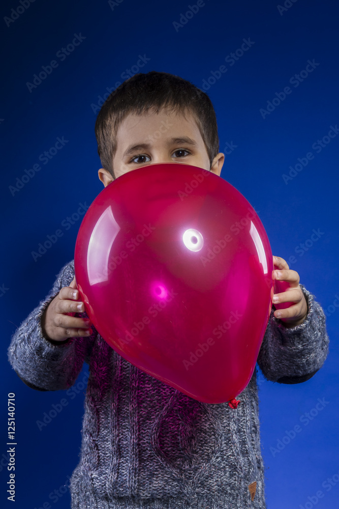 child playing with colored balloons at a birthday party happy child playing with colored balloons at a birthday party happy