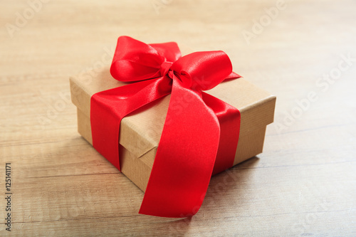 Gift box on wooden background © Rawf8