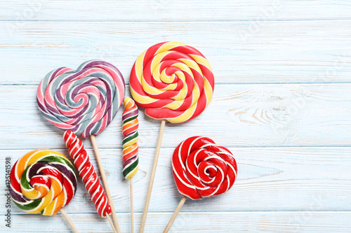 Sweet lollipops on a white wooden table