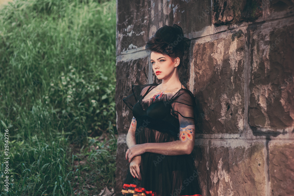 Obraz premium Charming girl in a beautiful dress on background of nature
