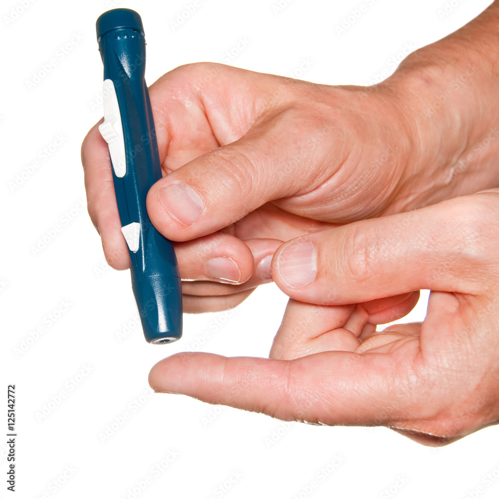 Diabetic lancet device in hand isolated on white. Diabetic lancet device in hand isolated on white.