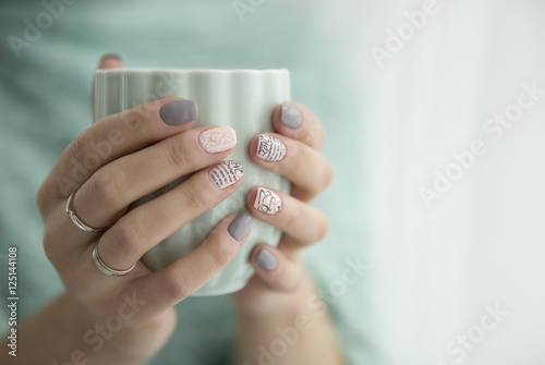 beautiful woman's hands holding a cup of mint
