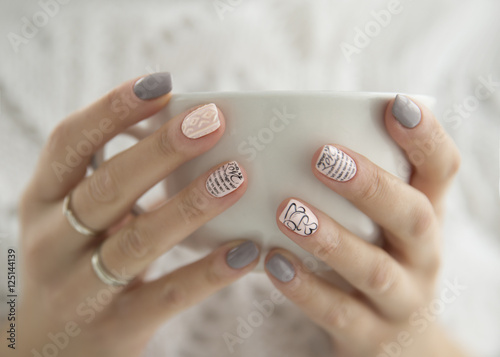 beautiful woman's hands holding a white cup