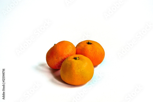 Three tangerines on a white background