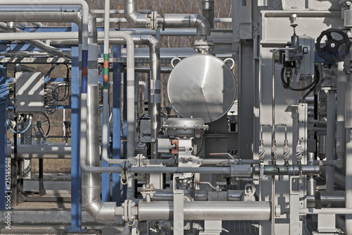 Details of a modern natural gas processing plant with pressure dials on gasworks pipes