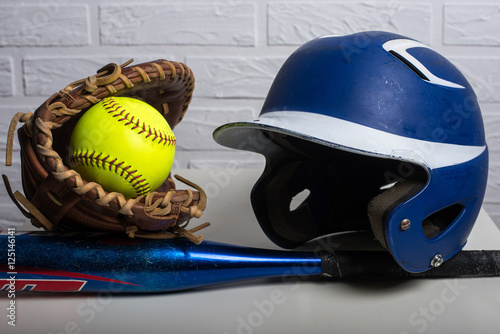 Yellow Softball, Helmet, Bat, and Glove  isolated on white background