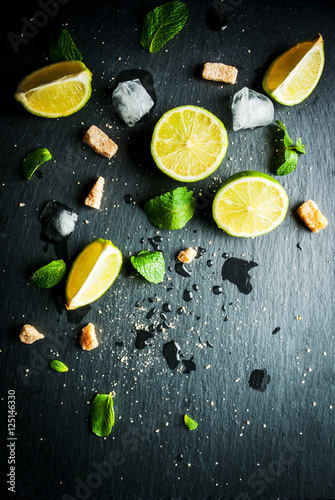 Ingredients for mojito or cocktail with tequila - lime, fresh mint, ice, brown sugar, close view