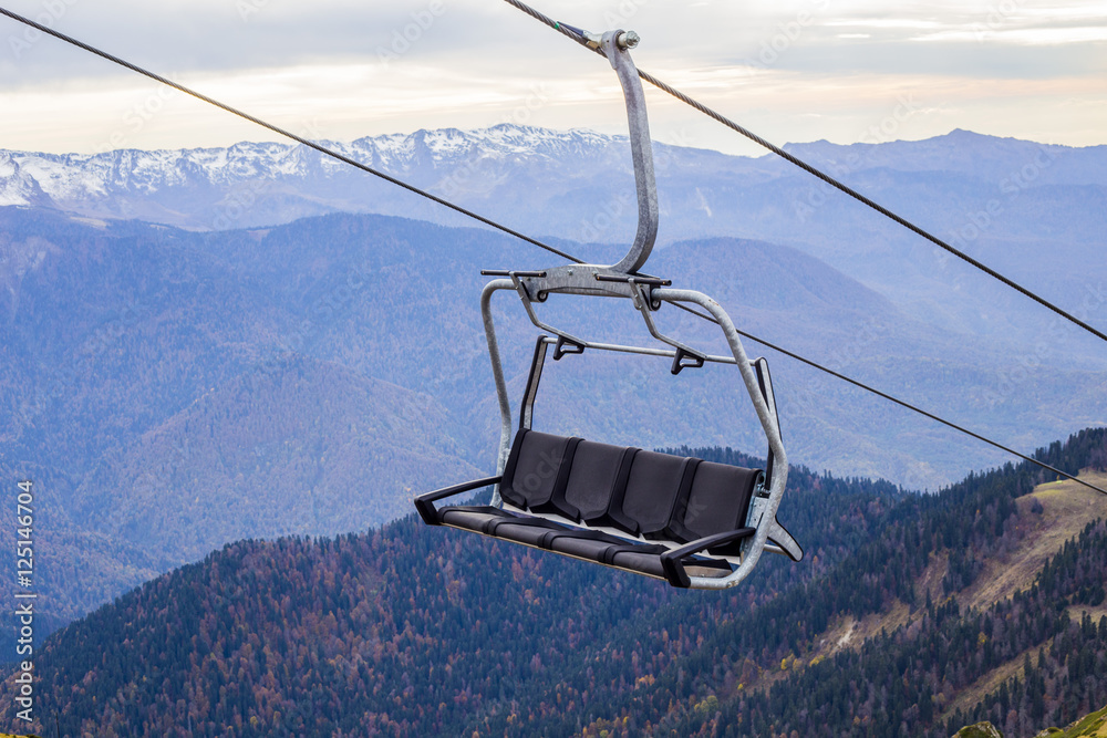 Open cabin of funicular in mountains at ski resort 