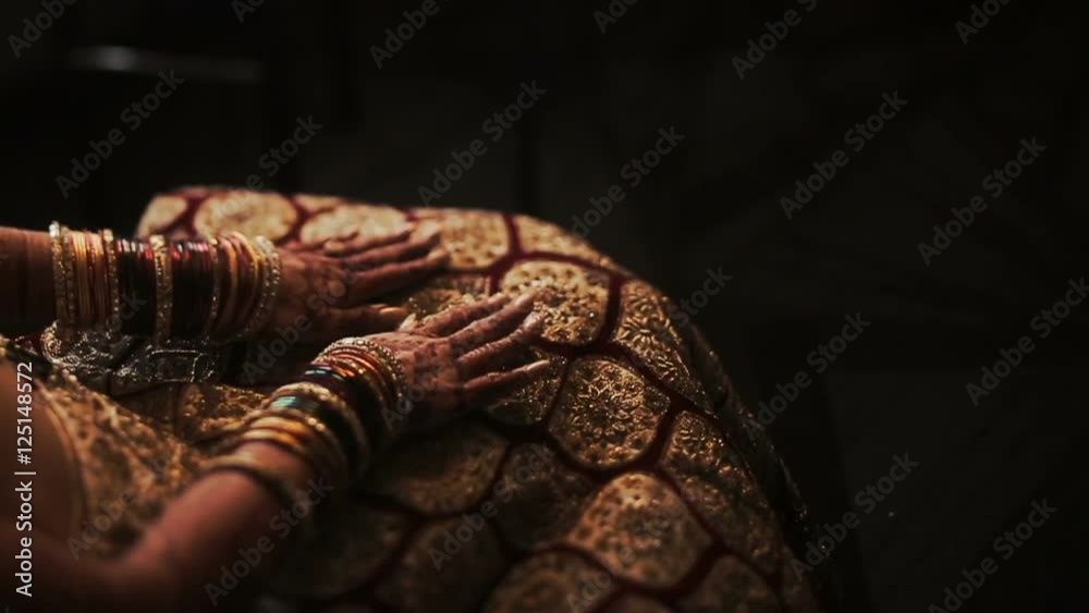 Mehndi covers delicate Indian bride's hands full of bracelets Mehndi covers delicate Indian bride's hands full of bracelets