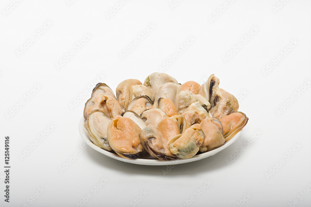 Marine mussels on a white saucer Marine mussels on a white saucer