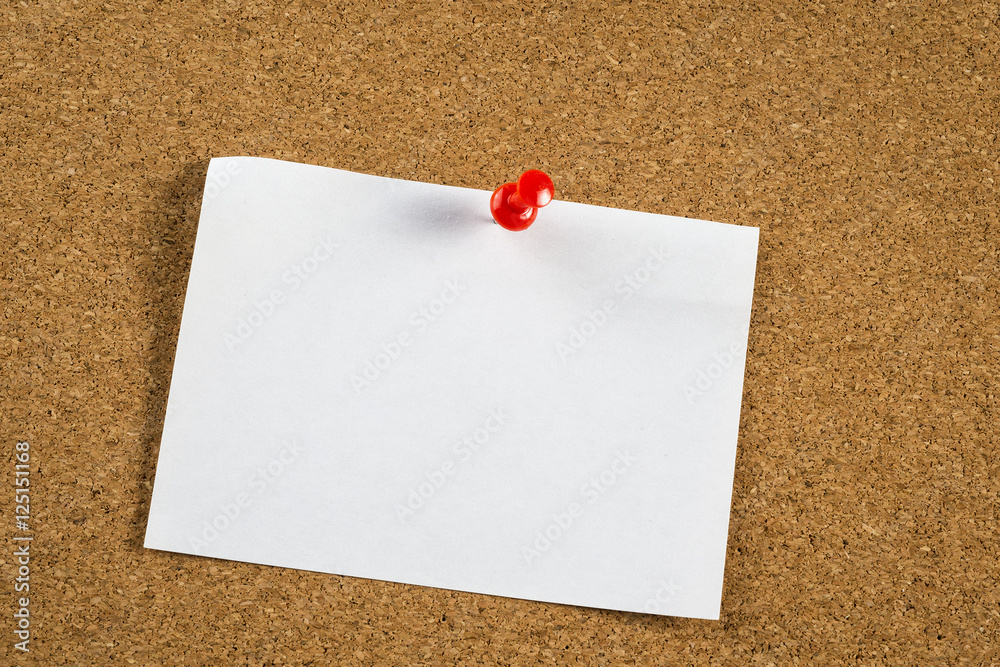 Thumbtack and note on corkboard Thumbtack and note on corkboard