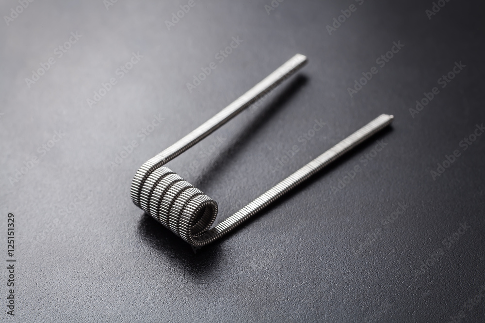 Tank track coil for vaping on a black background Tank track coil for vaping on a black background
