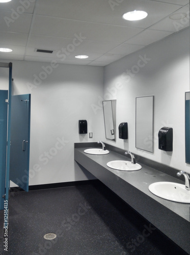 Clean simple public washroom sinks toilet stalls