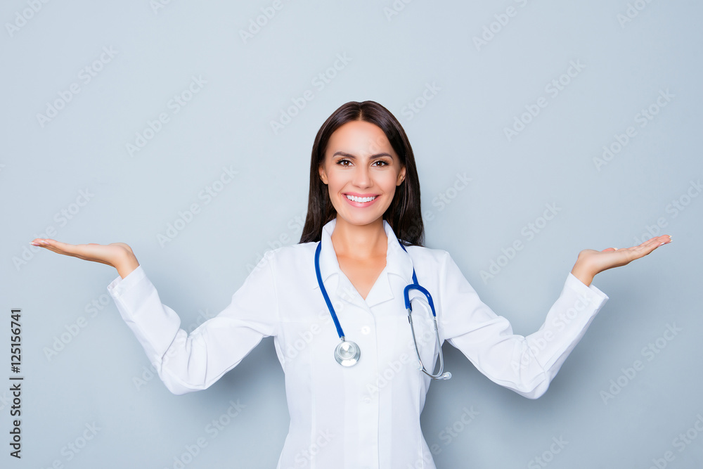 Portrait of cheerful young doctor making presentation of new med Portrait of cheerful young doctor making presentation of new med