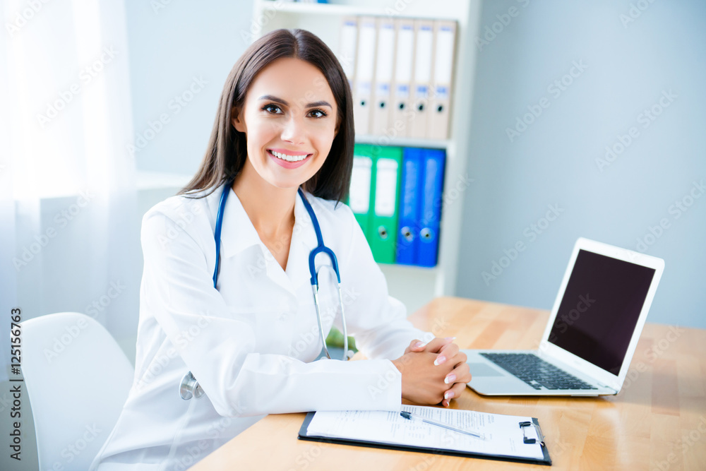 Portrait of cheerful happy female doctor on consultation Portrait of cheerful happy female doctor on consultation