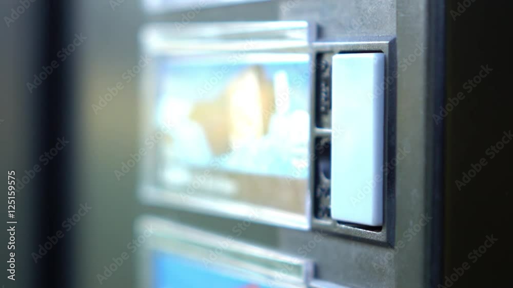 Button on vending machine pressed to purchase soda. Button on vending machine pressed to purchase soda.