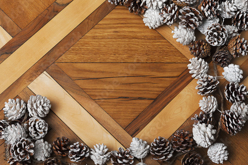Christmas pine cones on background of parquet