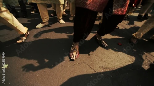 Look from above at feet of Hindu men dancing on the street
