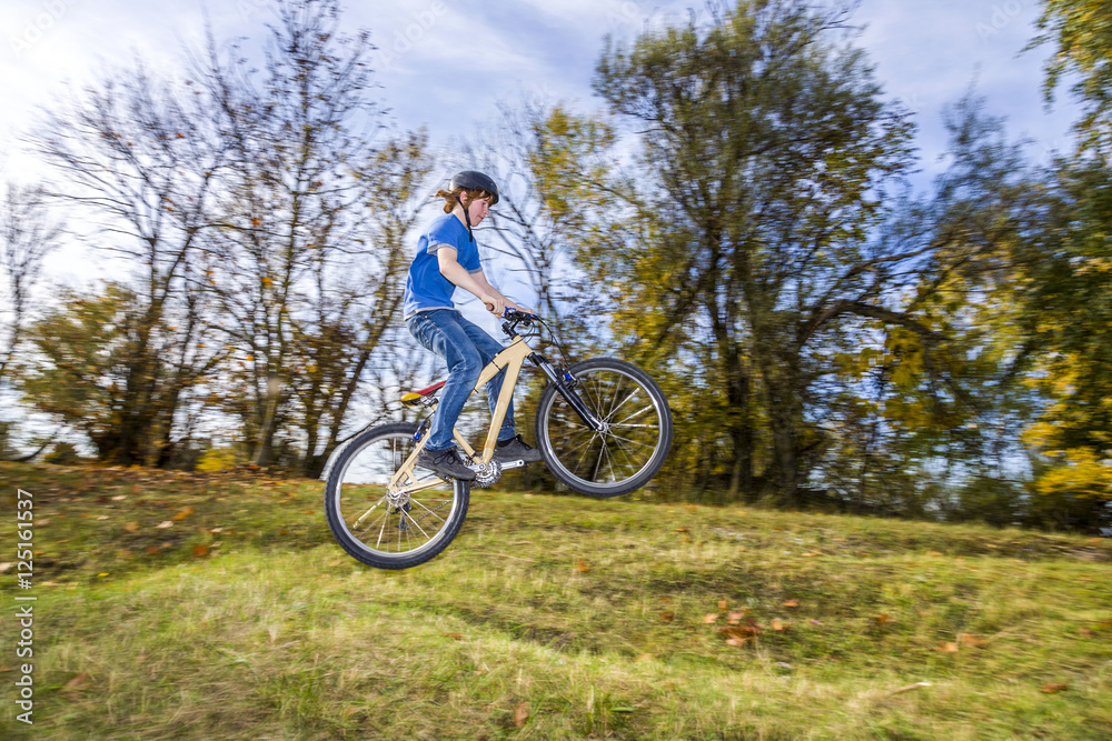 boy jumps over a ramp with his dirt bike