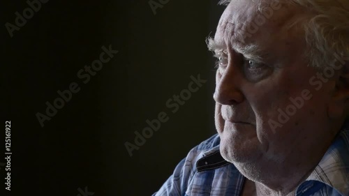 Mournful and alone elderly old man looking glum and grief-stricken