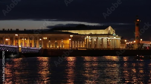 Russia, Saint-Petersburg, 28 March 2016: Night view of Old Stock Exchange Building and water area of Neva River at sunset, reflections, Birzhevoy, Dvorcovy, Palace bridge, Rastralnye columns photo