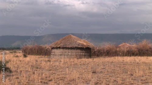 African village house made for dry branches, grass and animal dung.Dramatic sky in the background photo