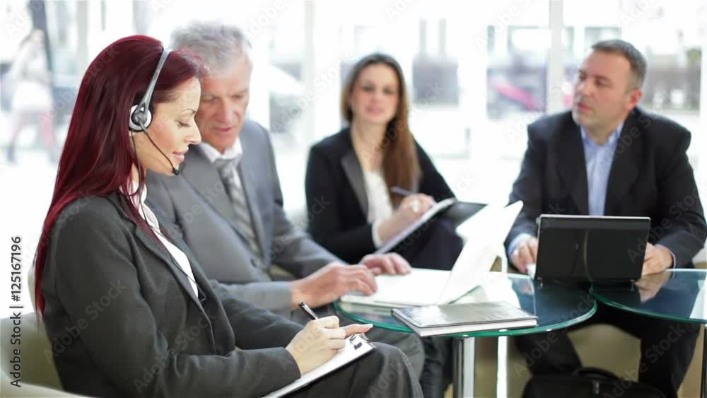 Business meeting between four business people Business meeting between four business people