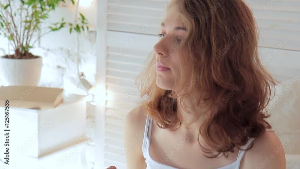 Cute young woman drinks coffee from a mug with marshmallows Cute young woman drinks coffee from a mug with marshmallows