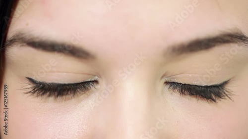 Young beautiful woman with striking brown eyes, make-up. Shallow depth of field. closeup. photo