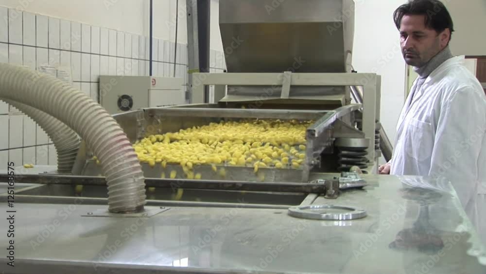 Man in lab coat controlling a quality. Factory for the production of corn flakes. Please see my other videos with the same theme.