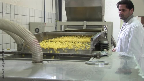 Man in lab coat controlling a quality. Factory for the production of corn flakes. Please see my other videos with the same theme.