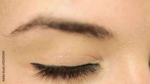 Young beautiful woman with striking brown eyes, make-up. Shallow depth of field. Closeup. closeup. photo