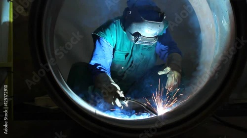 Welder inside Pipe, Welding the Seam to Create One Continuous Section of Pipe. 