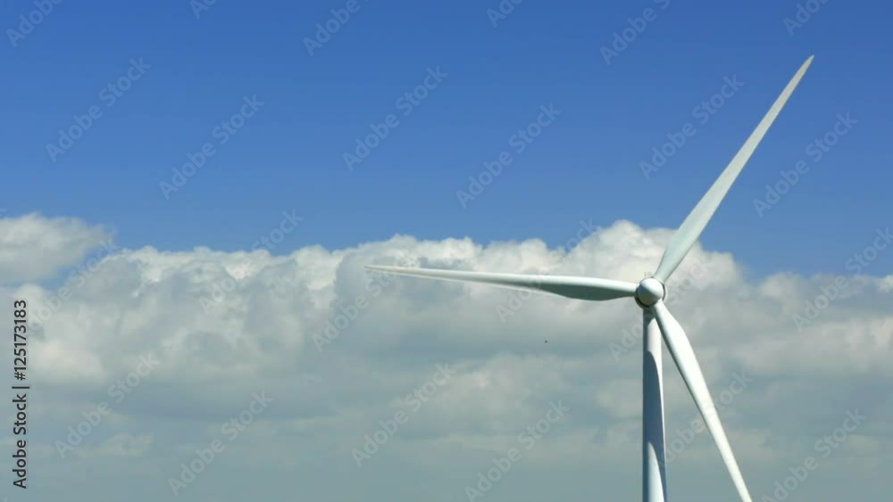 Low angle view of modern windmill under the blue clear sky. Copy space.4k Low angle view of modern windmill under the blue clear sky. Copy space.4k