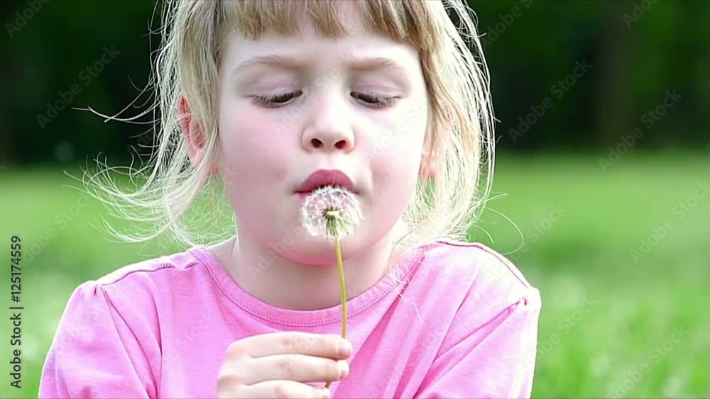 Little girl blowing dandelion, slow motion, high speed camera Little girl blowing dandelion, slow motion, high speed camera