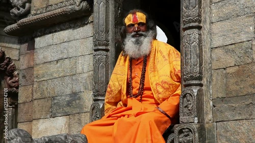 Portrait of Holy Sadhu man with long beard and traditional face paint in Pashupatinath Temple, Kathamandu, Nepal.