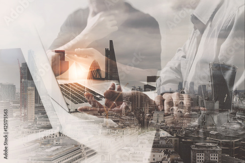 Double exposure of success businessman working in office with di