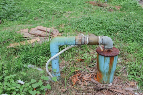 Water valve Plumbing Steel dilapidated on grass. 