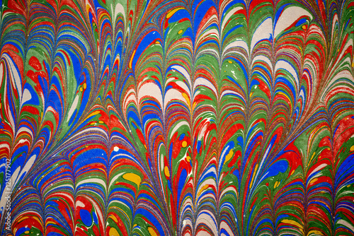 Ebru art. Traditional Turkish Ebru technique. Painting on water, followed by paper prints. Color paint ebru with waves and tile pattern.