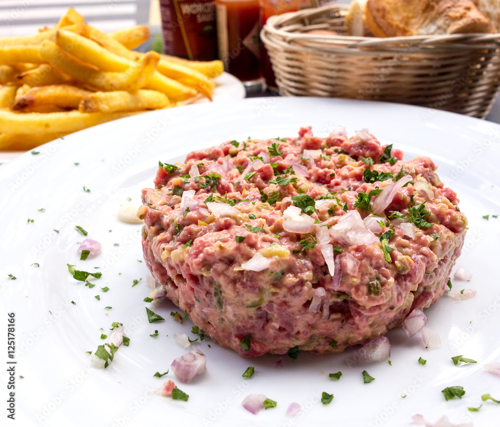tasty Steak tartare (Raw beef) - classic steak tartare on white tasty Steak tartare (Raw beef) - classic steak tartare on white