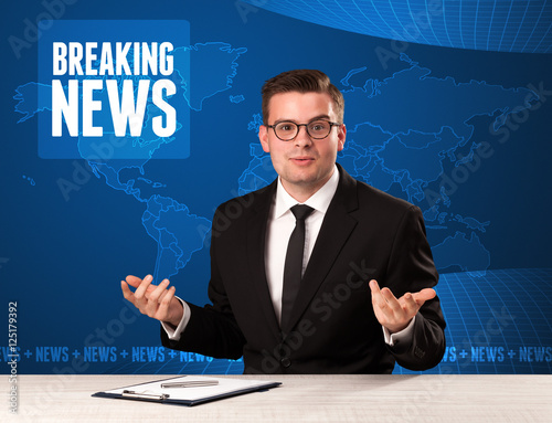 Television presenter in front telling breaking news with blue mo