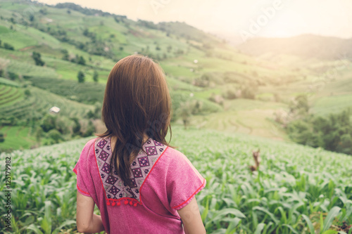 Woman traveler looking at green rice terraces field