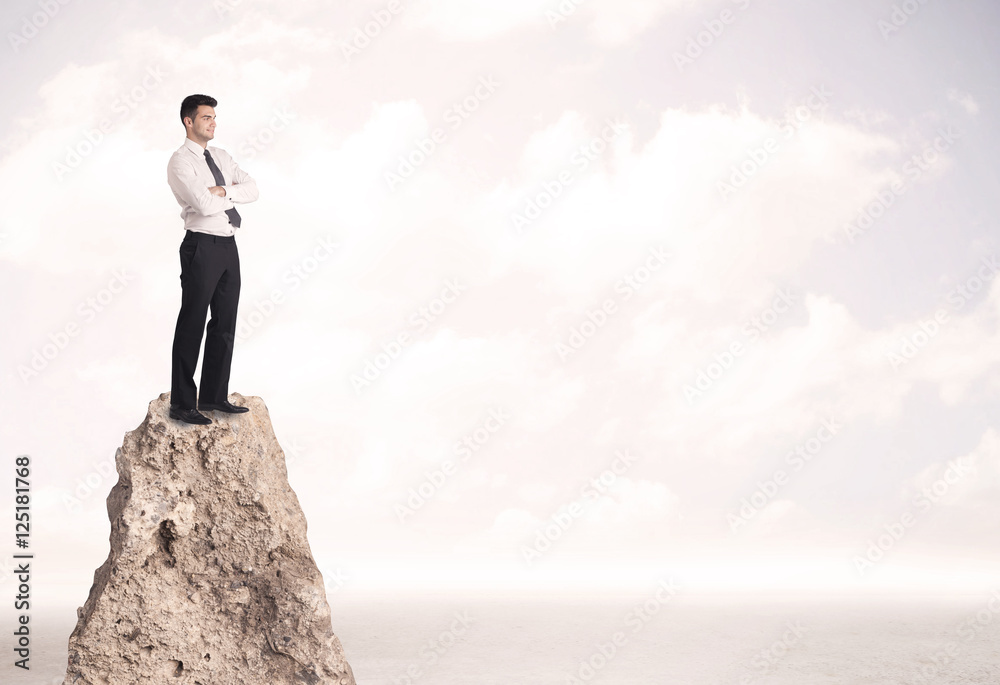 Happy businessman standing on cliff Happy businessman standing on cliff