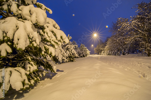 Background with winter snow night walkway and lights